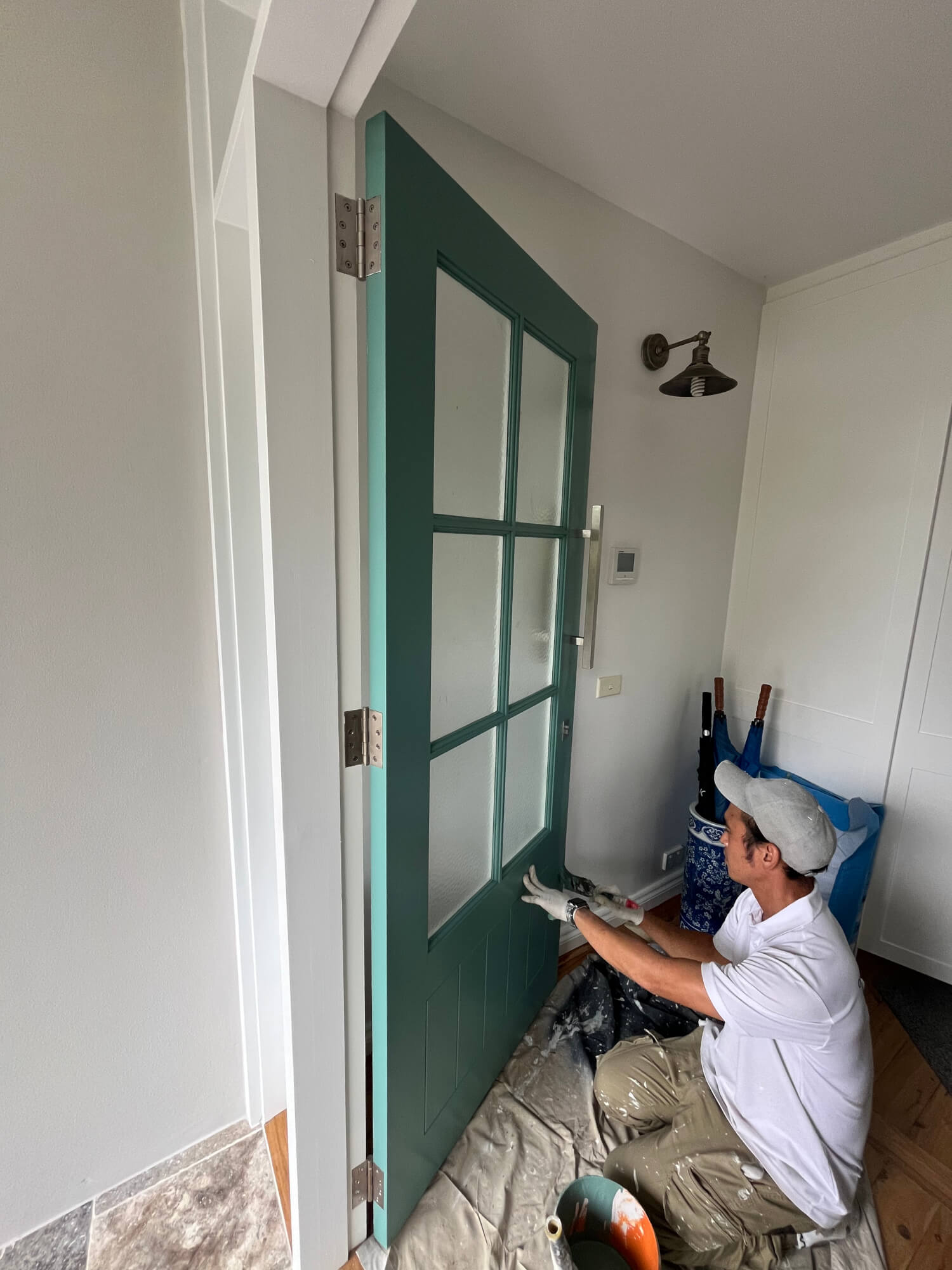 house painter painting a door 