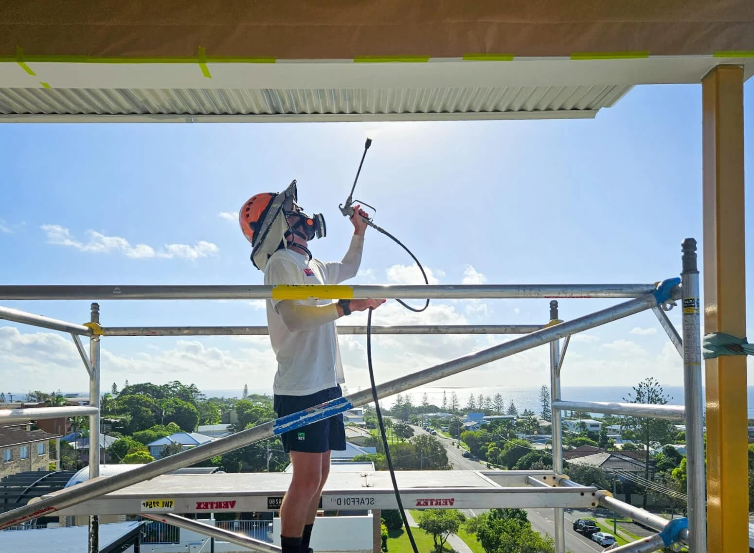 professional painter maintaining coastal apartment
